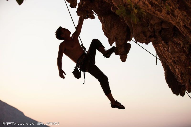 登山运动勇敢攀岩的男人图片